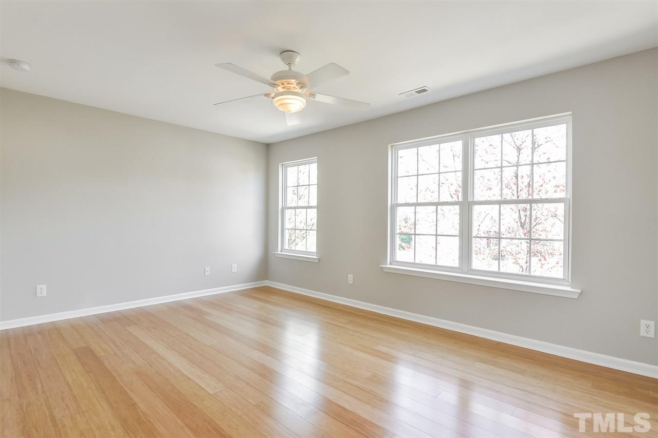 5100 Marathon Lane Raleigh, NC 27616 - Photo 20 of 24 an empty room with wooden floor and windows