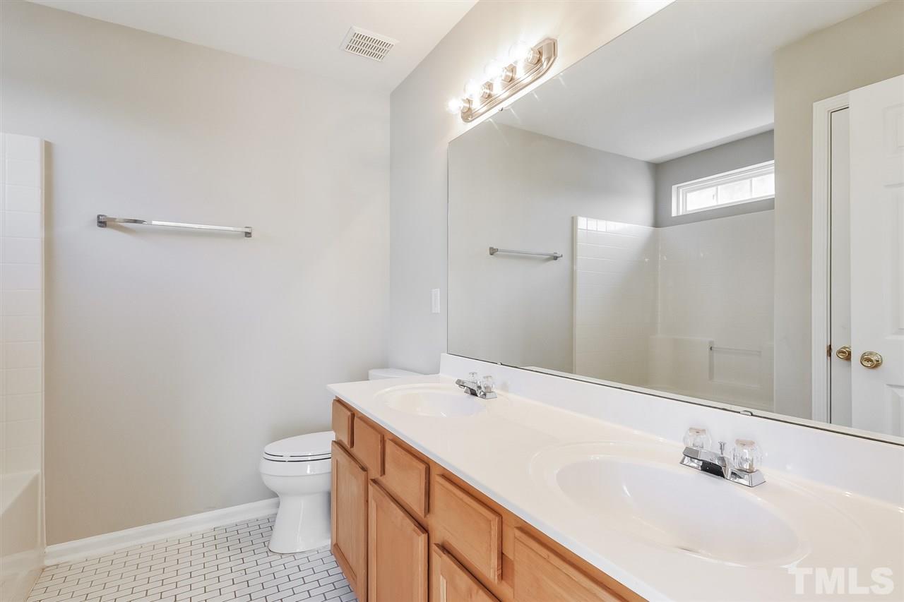 5100 Marathon Lane Raleigh, NC 27616 - Photo 22 of 24 a bathroom with a sink a toilet and shower