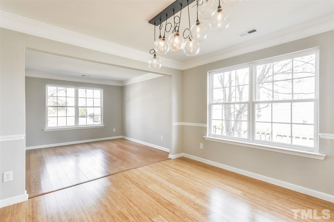 5100 Marathon Lane Raleigh, NC 27616 - Photo 4 of 24 a view of an empty room with a window and wooden floor