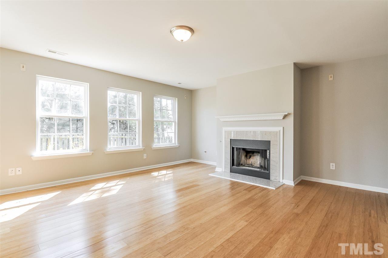 5100 Marathon Lane Raleigh, NC 27616 - Photo 7 of 24 an empty room with windows and a fireplace