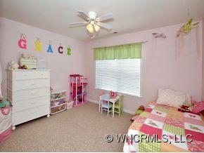 30 Woodfern Road Fletcher, NC 28732 - Photo 11 of 19 a bedroom with a bed and a chandelier