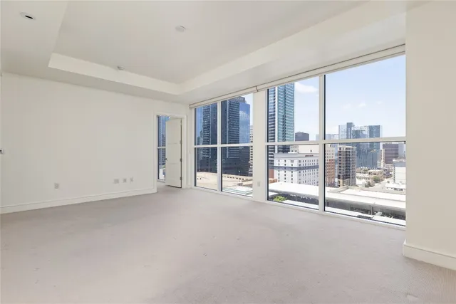 a spacious bathroom with a granite countertop sink mirror and a bathtub