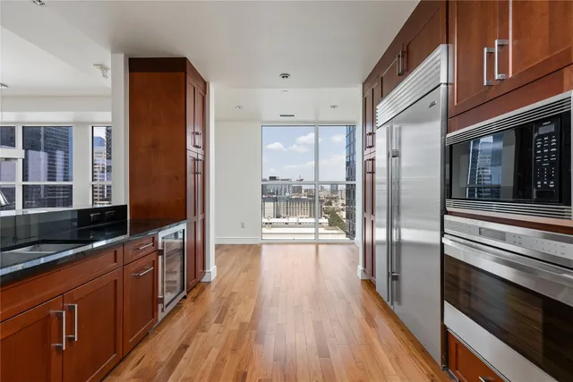 a kitchen with granite countertop a sink and a black white cabinets