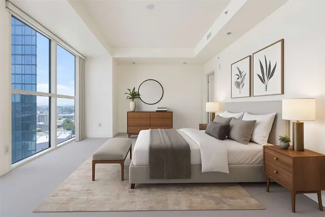 a bedroom with a bed and large window