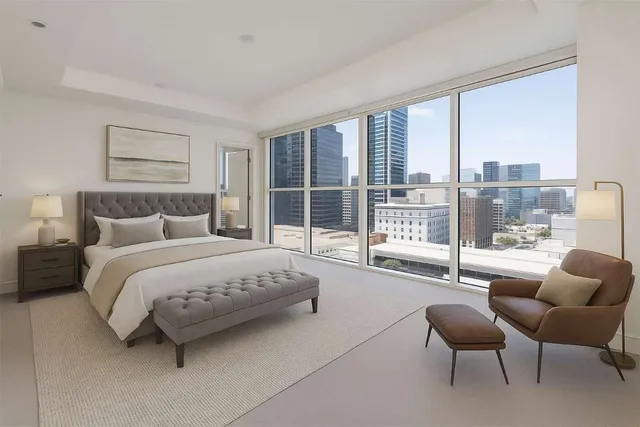 a spacious bedroom with a bed and glass window
