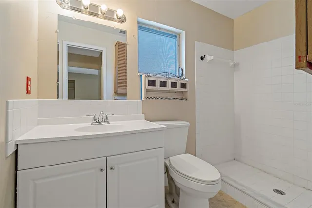 a bathroom with a shower and toilet