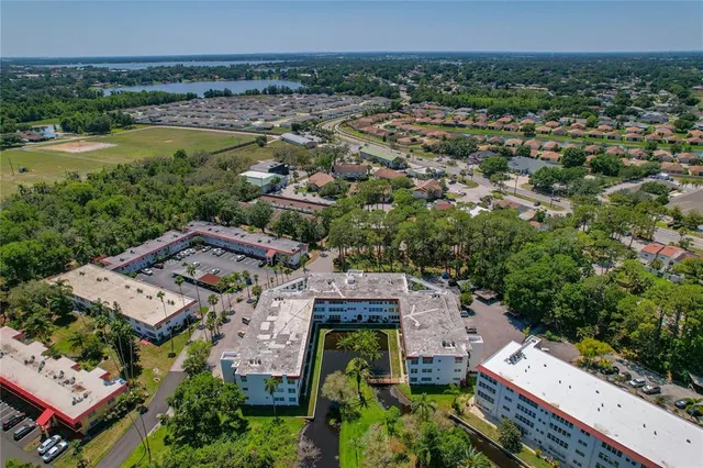 an aerial view of a house with a yard