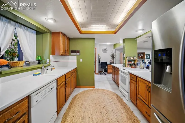 a large kitchen with stainless steel appliances a lot of counter space and a window