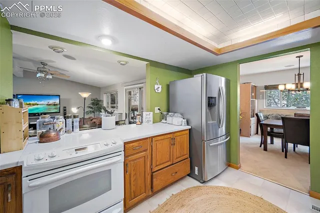 a kitchen with refrigerator and cabinets