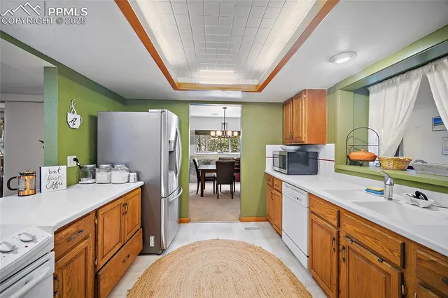 a kitchen that has a lot of cabinets in it and wooden floors