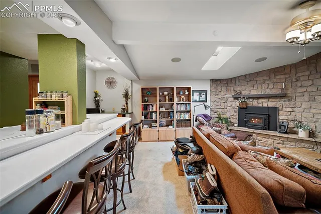 a living room with furniture a bookshelf and a fireplace