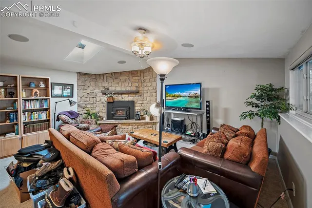 a living room with furniture a fireplace and a chandelier