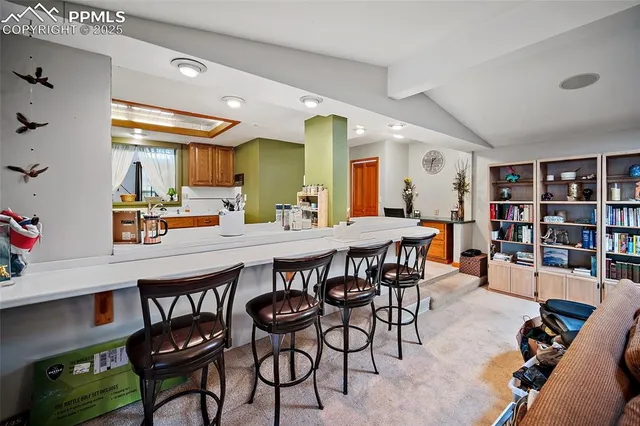 a dining area with stainless steel appliances a dining table and chairs