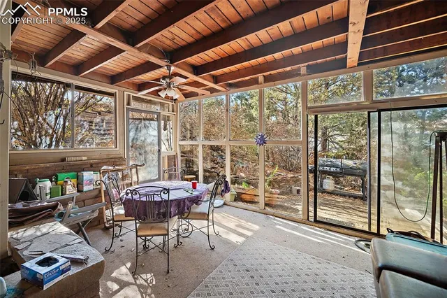 a patio with yard glass top table and chairs