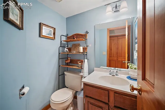 a bathroom with a sink a toilet and mirror