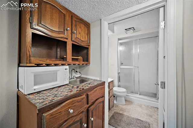 a kitchen with stainless steel appliances a stove microwave and cabinets