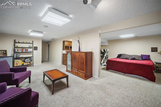 a spacious bedroom with a bed and furniture