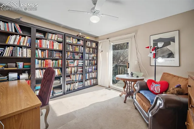 a living room with furniture and a book shelf