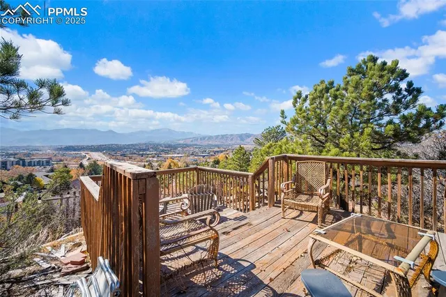 a view of a balcony with wooden floor and city view