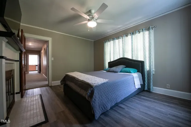 a bedroom with a large bed and a chandelier