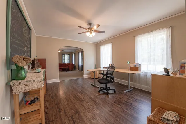 a living room with furniture and a wooden floor