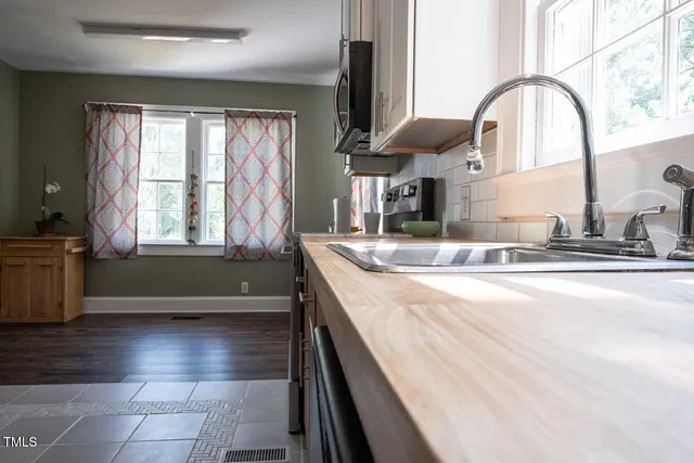 a kitchen with a sink and a large window