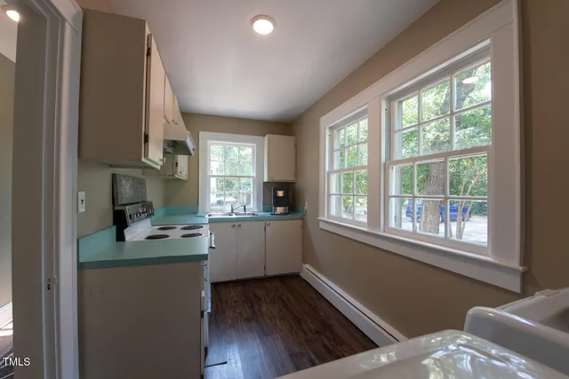 a kitchen with sink cabinets and wooden floor