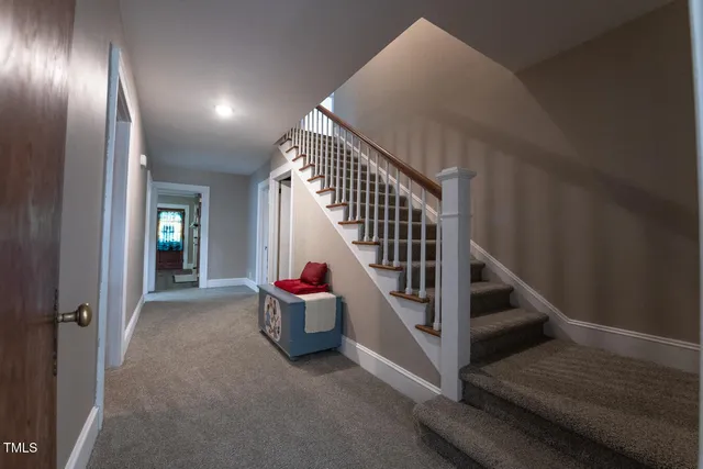 a view of entryway and hall with a front door