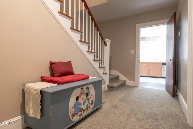 a living room with furniture and stairs