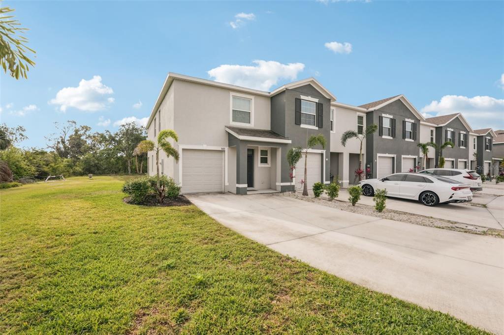 a front view of a house with a yard and garage