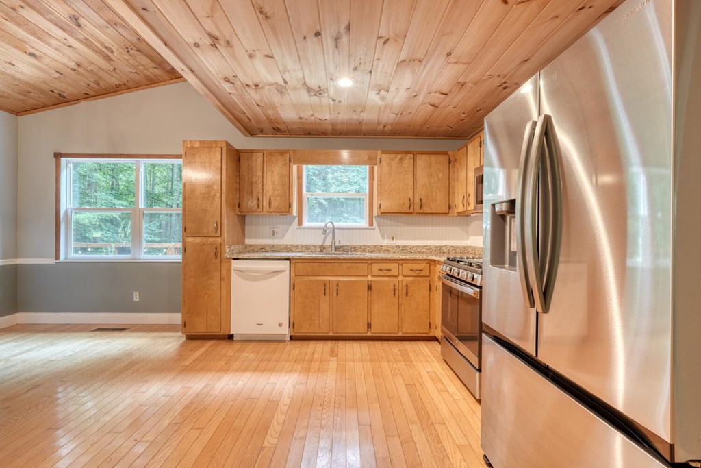 550 Watson Road Epworth, GA 30541 - Photo 20 of 63 a kitchen with a refrigerator wooden floor window and a sink