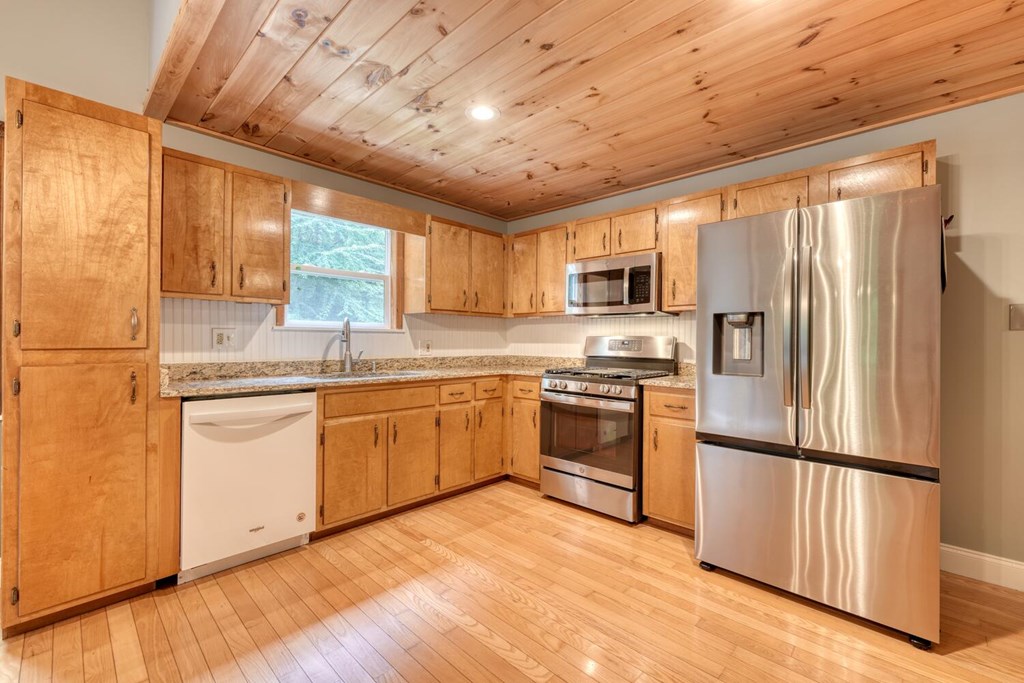550 Watson Road Epworth, GA 30541 - Photo 21 of 63 a kitchen with granite countertop a refrigerator stove top oven and sink