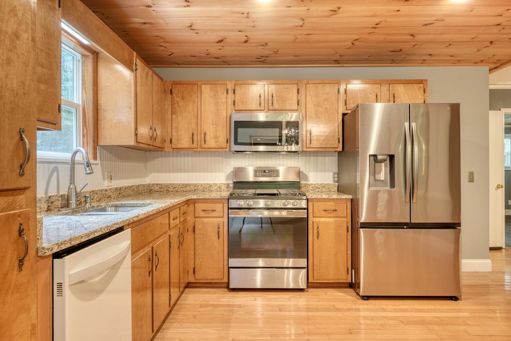 550 Watson Road Epworth, GA 30541 - Photo 22 of 63 a kitchen with granite countertop a refrigerator and a sink