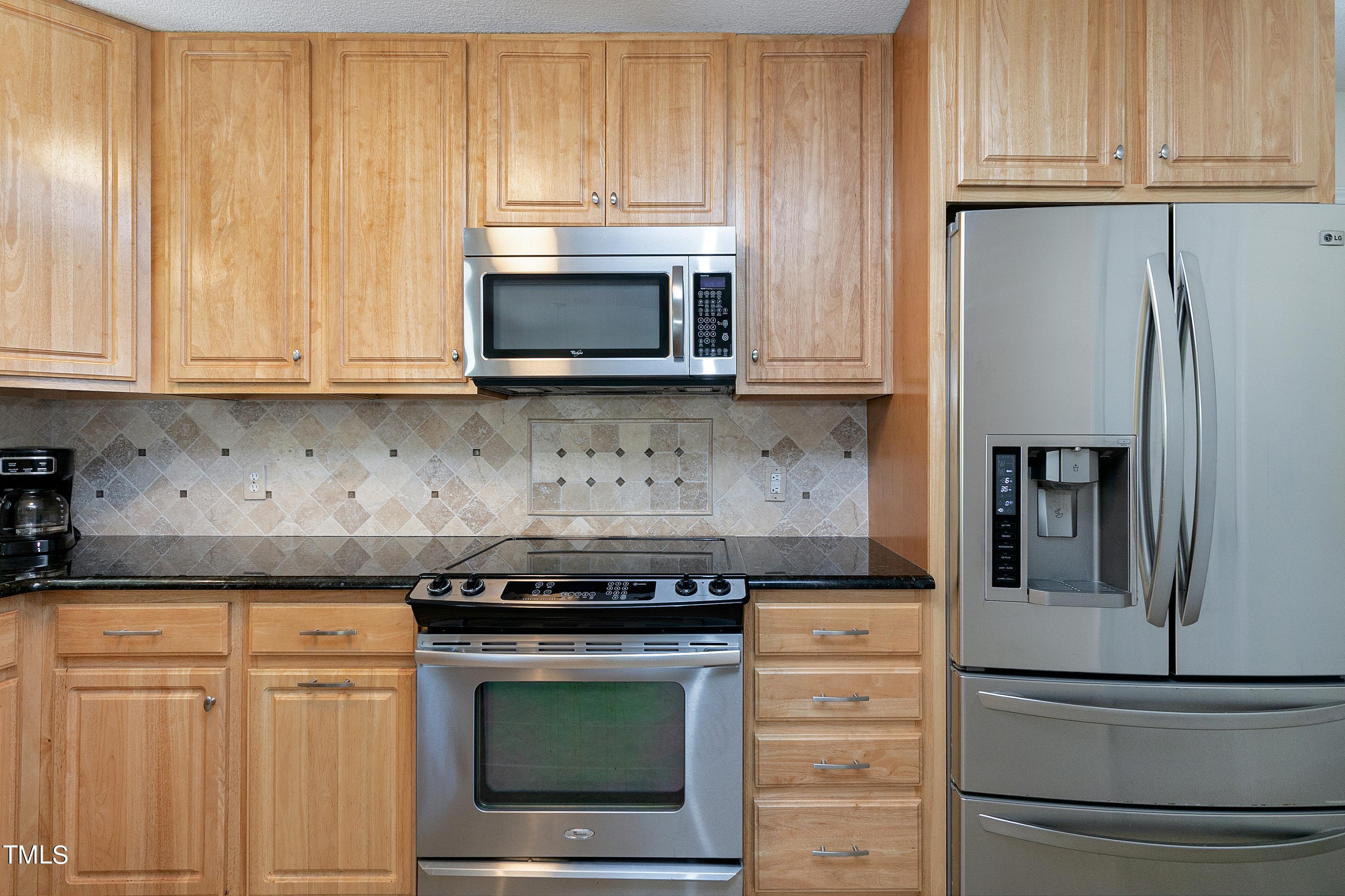 3900 Old Coach Road Raleigh, NC 27616 - Photo 8 of 23 Stainless appliances and tile backsplash...
