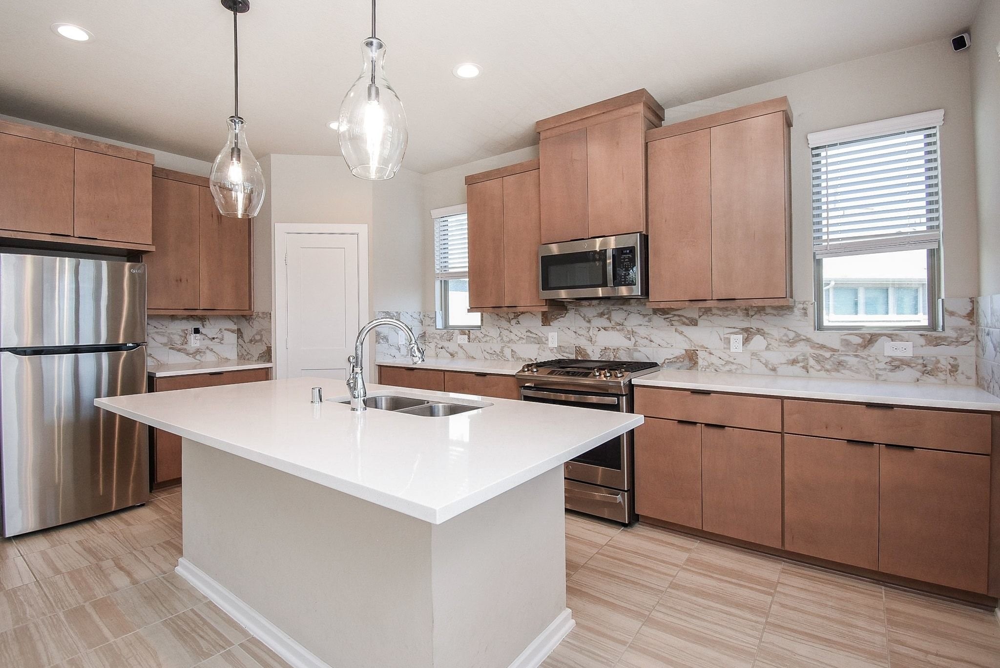 7643 Green Bulrush Way Katy, TX 77493 - Photo 11 of 20 a kitchen with stainless steel appliances granite countertop a sink stove and refrigerator