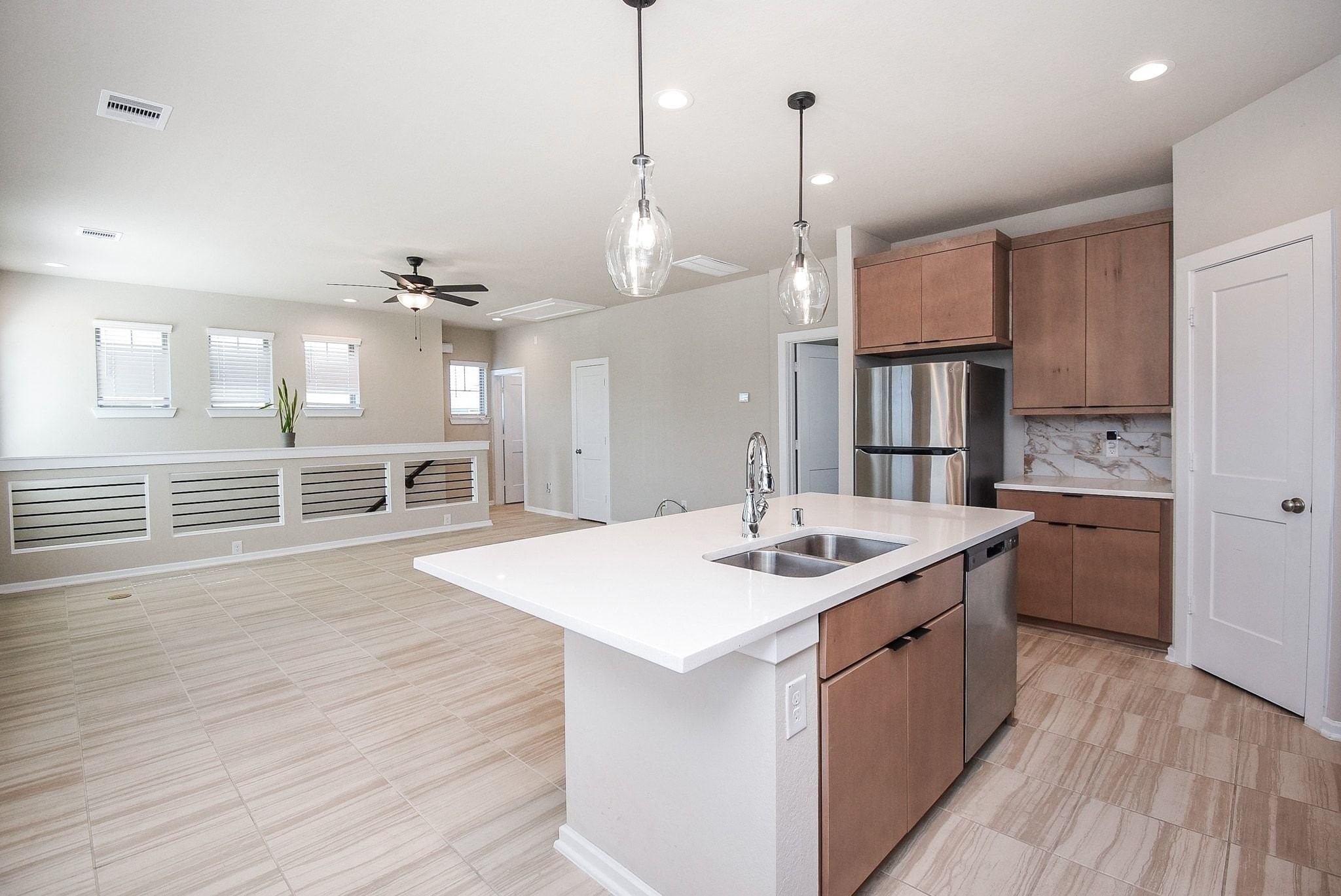 7643 Green Bulrush Way Katy, TX 77493 - Photo 12 of 20 a kitchen with stainless steel appliances granite countertop a sink a stove and a wooden floors