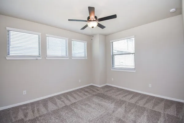 a view of room with window and ceiling fan