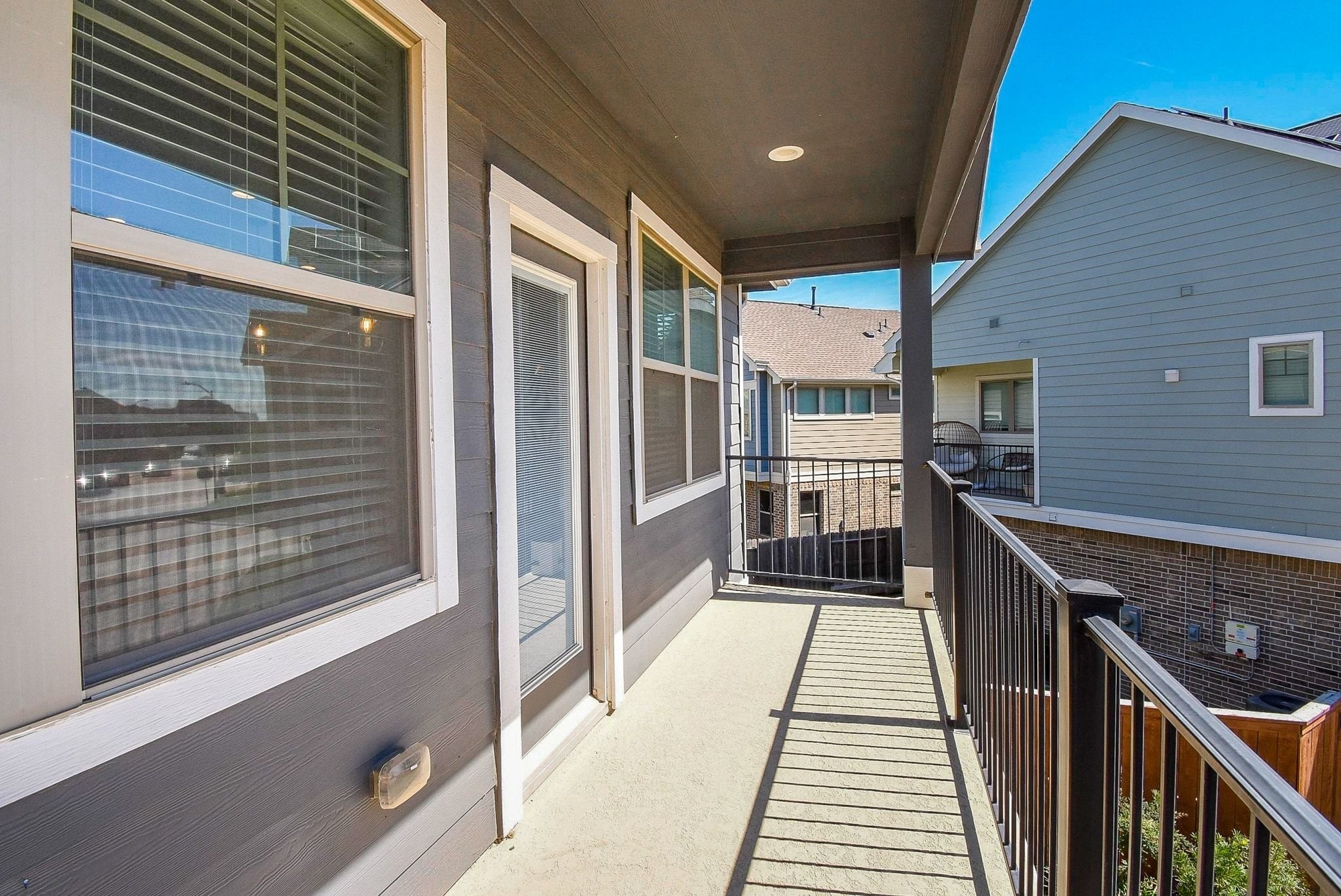 7643 Green Bulrush Way Katy, TX 77493 - Photo 15 of 20 a view of a balcony with wooden floor and stairs
