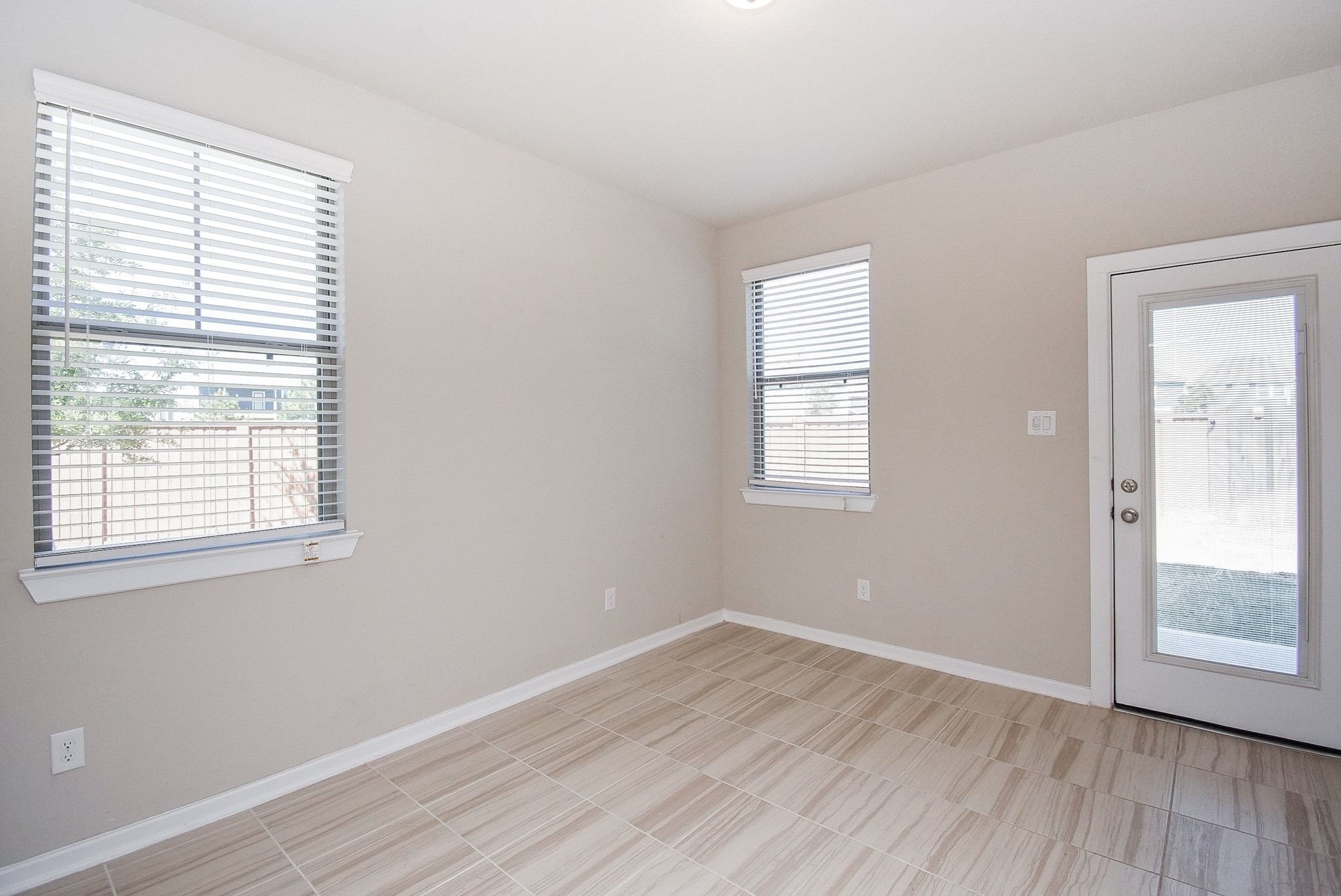 7643 Green Bulrush Way Katy, TX 77493 - Photo 4 of 20 an empty room with wooden floor and windows