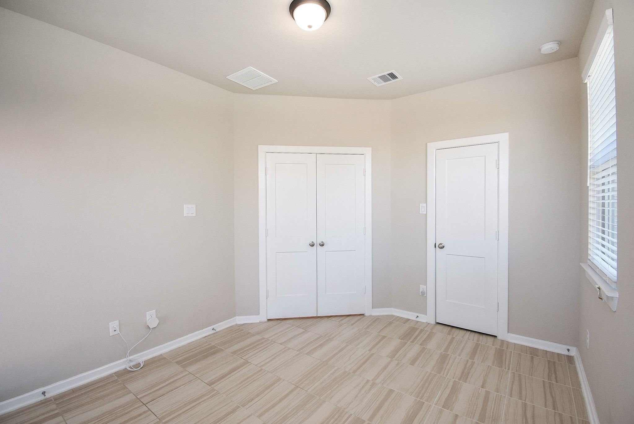 7643 Green Bulrush Way Katy, TX 77493 - Photo 5 of 20 a view of an empty room with wooden floor and a window