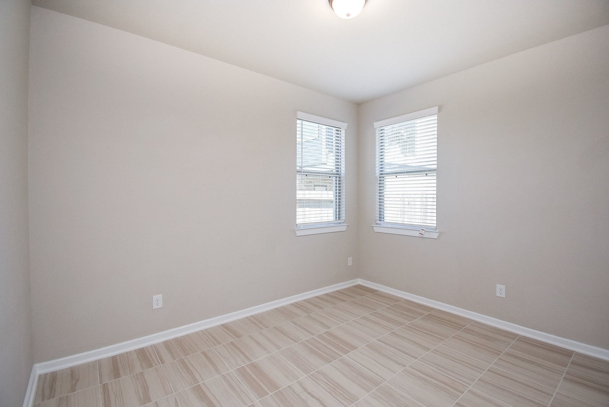 7643 Green Bulrush Way Katy, TX 77493 - Photo 7 of 20 wooden floor in an empty room with a window