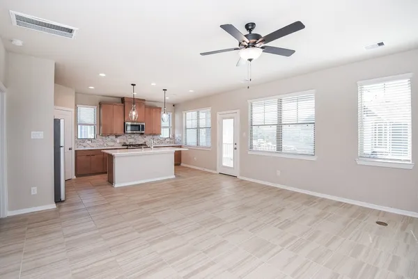 a view of kitchen with cabinets microwave and window
