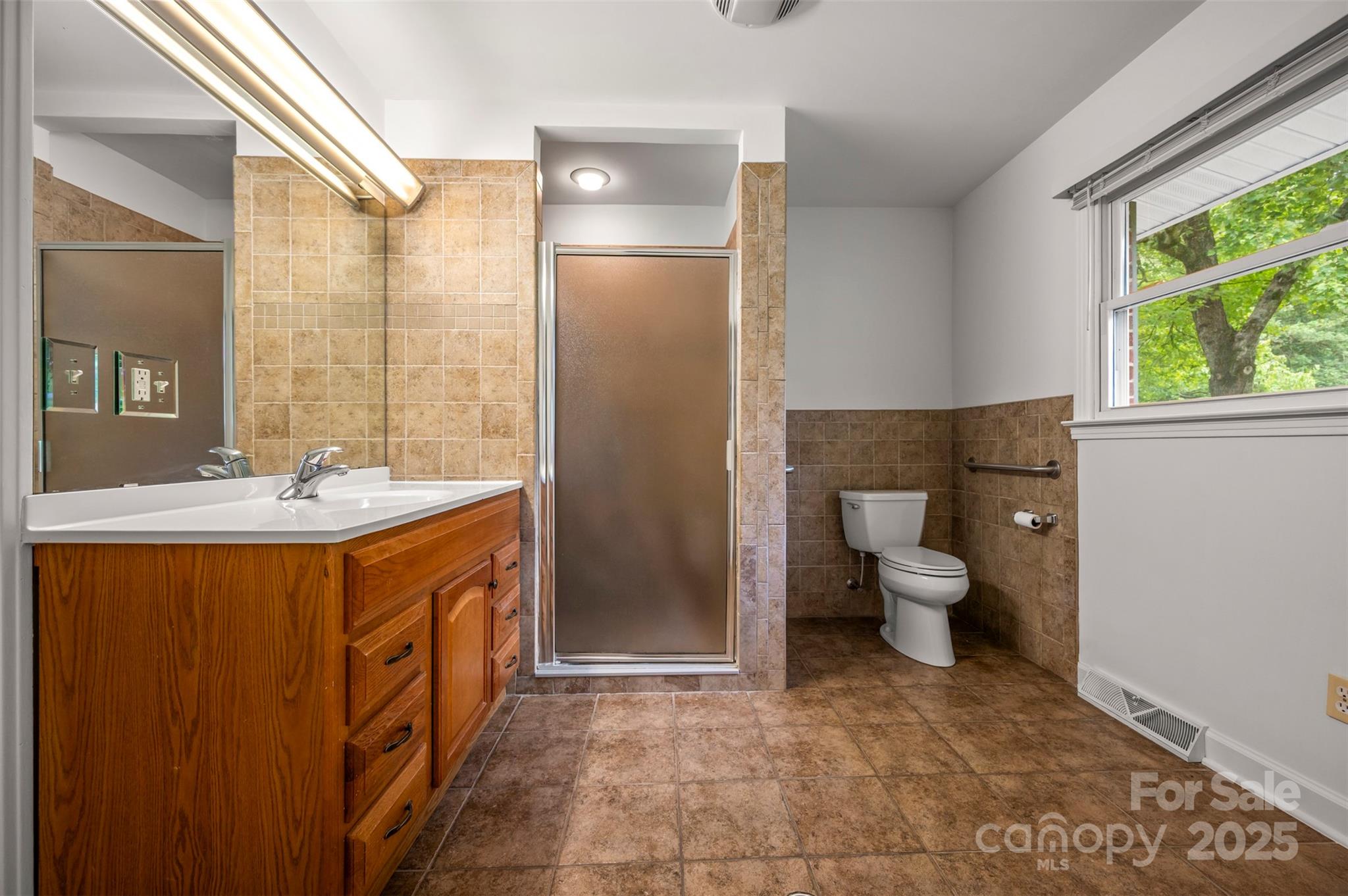 170 Hodge Street Rutherfordton, NC 28139 - Photo 19 of 48 a spacious bathroom with a double vanity sink toilet and a mirror