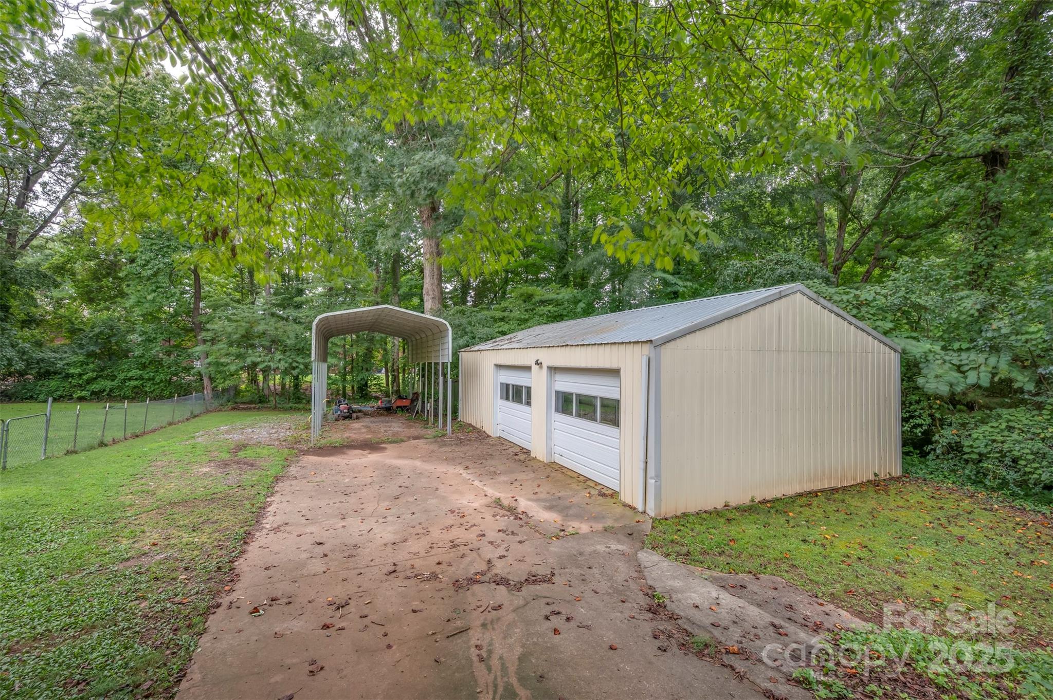 170 Hodge Street Rutherfordton, NC 28139 - Photo 44 of 48 a backyard of a house with table and chairs under an umbrella