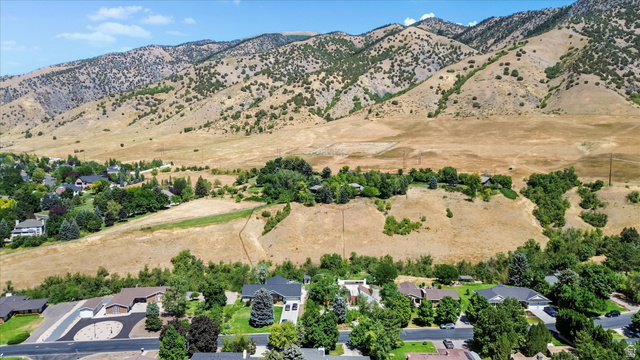 510 Spring Creek Road Providence, UT 84332 - Photo 69 of 97 Expansive mountain landscape backdrop with residential properties nestled amongst mature trees