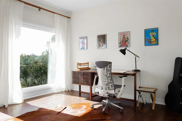a living room with a toilet and a window