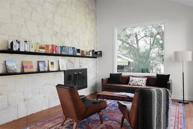 a living room with furniture and a fireplace