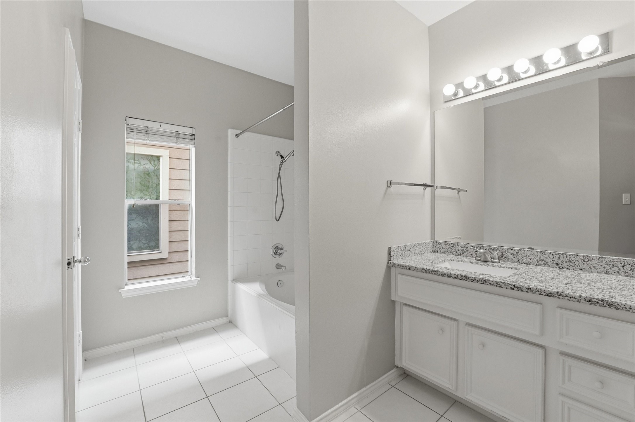 1507 Sutton Street Houston, TX 77006 - Photo 14 of 31 a bathroom with a granite countertop sink a mirror and a shower