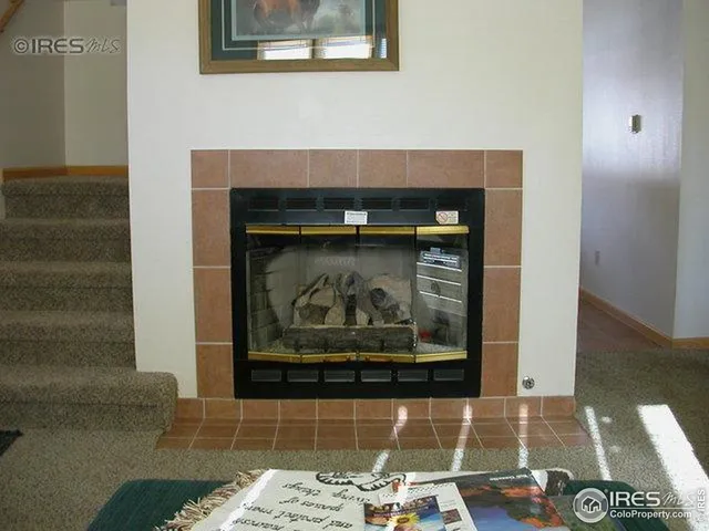 a kitchen with granite countertop a refrigerator stove and microwave