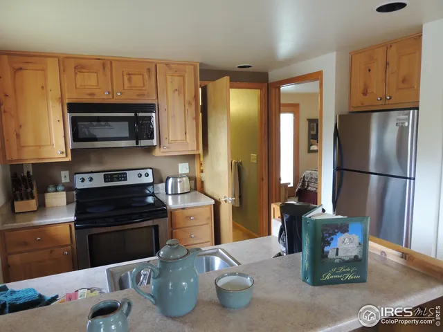 a bedroom with a bed a lamp and a large window